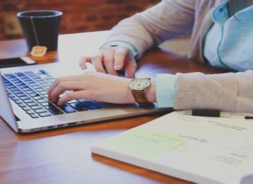 1woman-sitting-at-table-and-using-laptop-with-tea-cup-in-background(1)